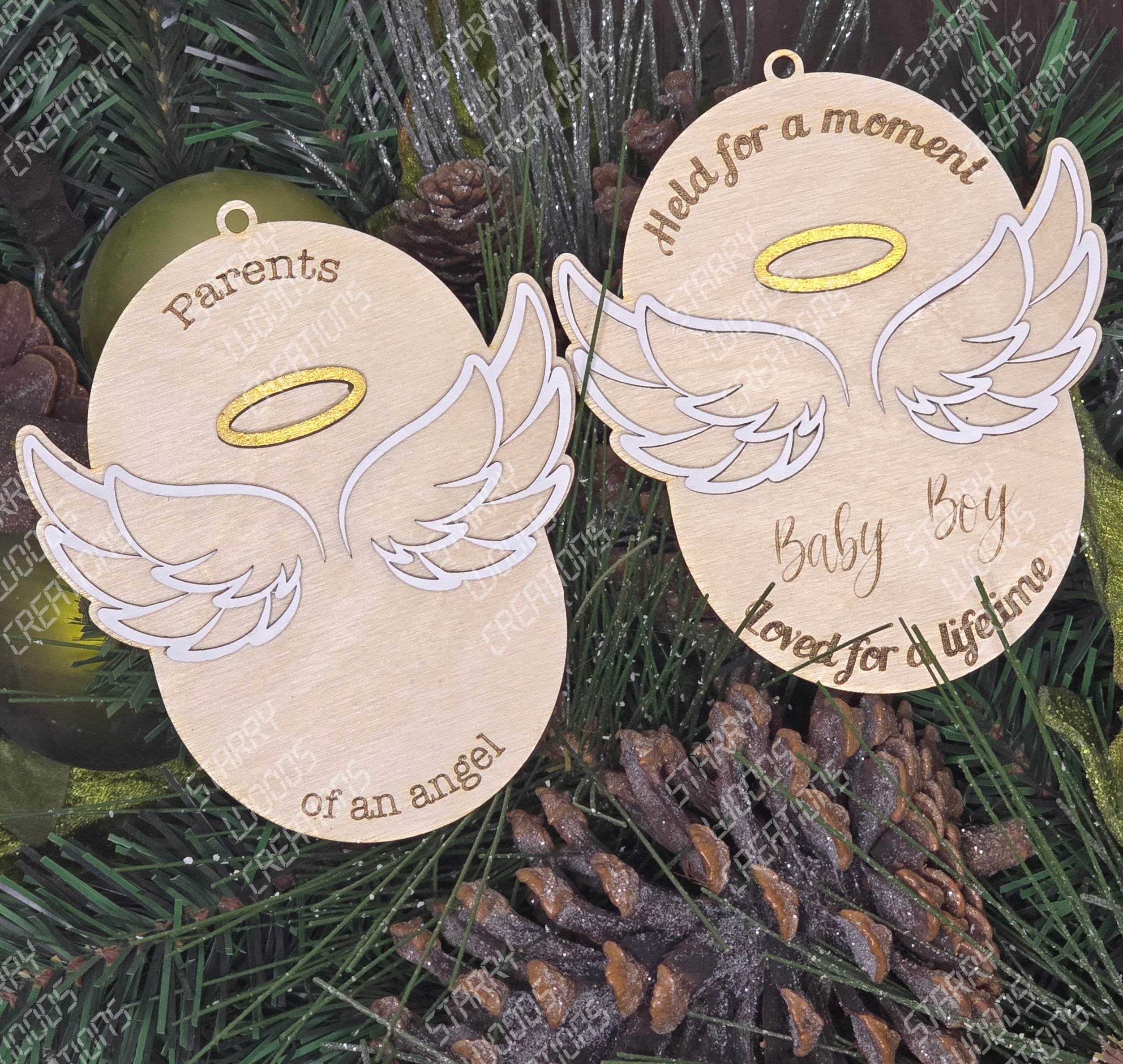 Two angel wing ornaments with text on a green leaf background. Handmade and customizable.