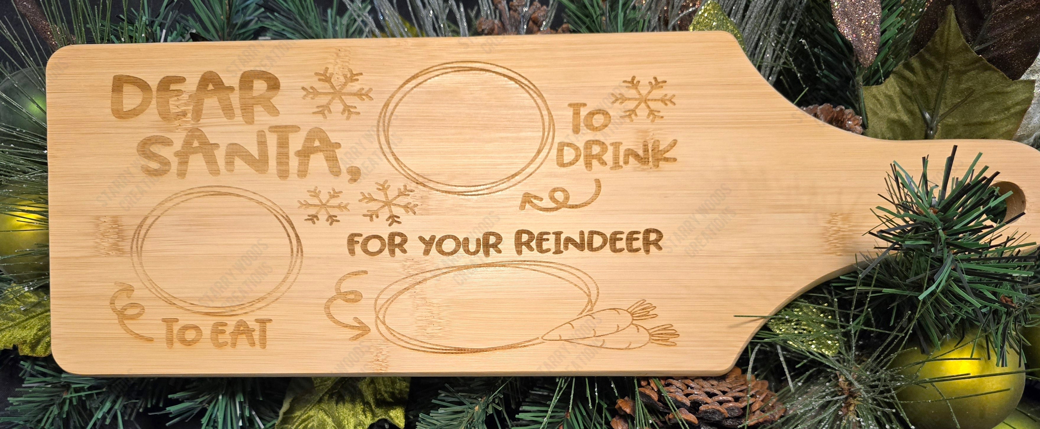 Wooden cutting board with engraved text for Santa and reindeer on a Christmas-themed background, perfect for family traditions and gifting 