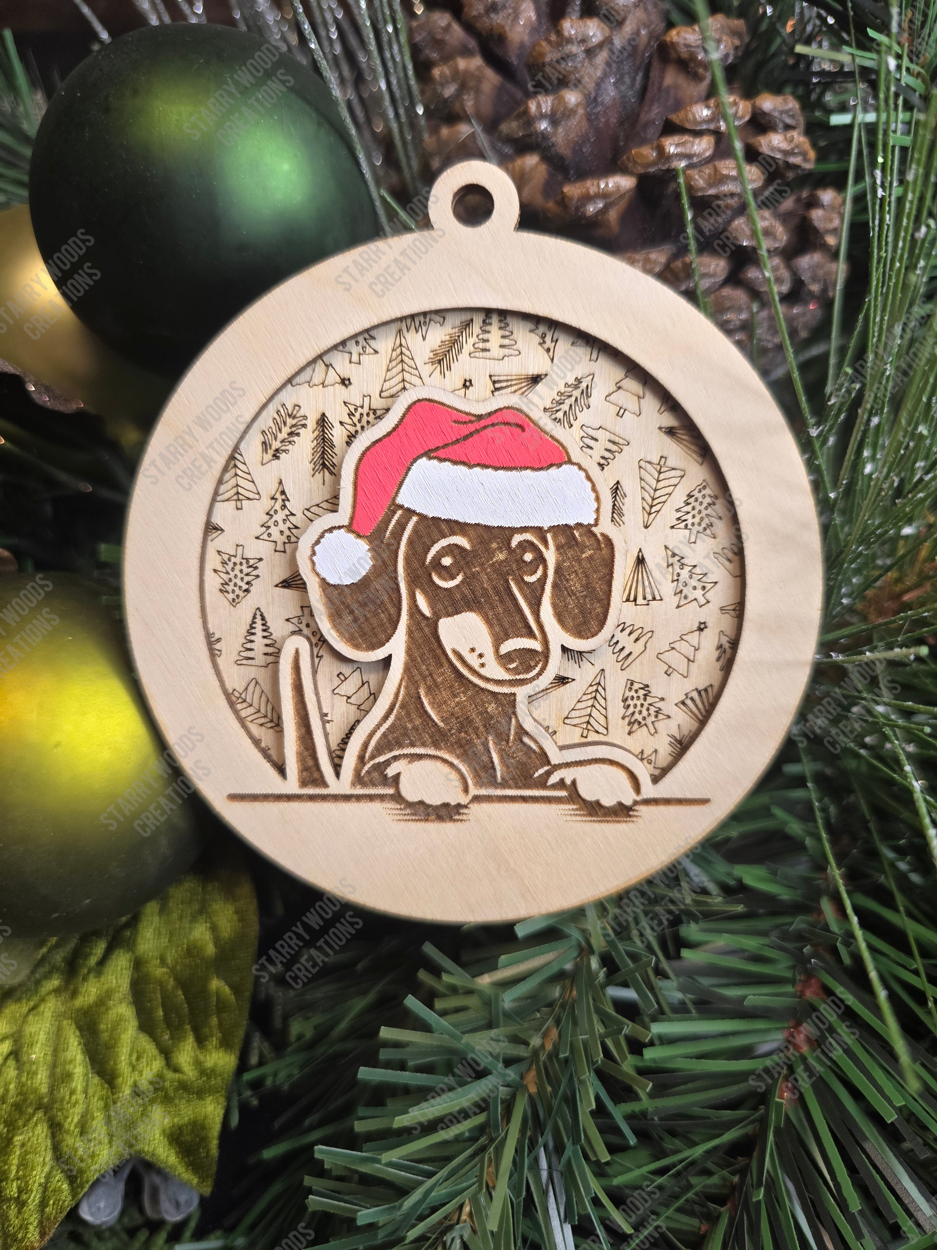 Wooden Christmas ornament with a dachshund wearing a Santa hat on a green Christmas tree background.