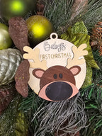 Decorative reindeer ornament with 'First Christmas' text on a Christmas tree. Handmade in Quinte West and customizable.