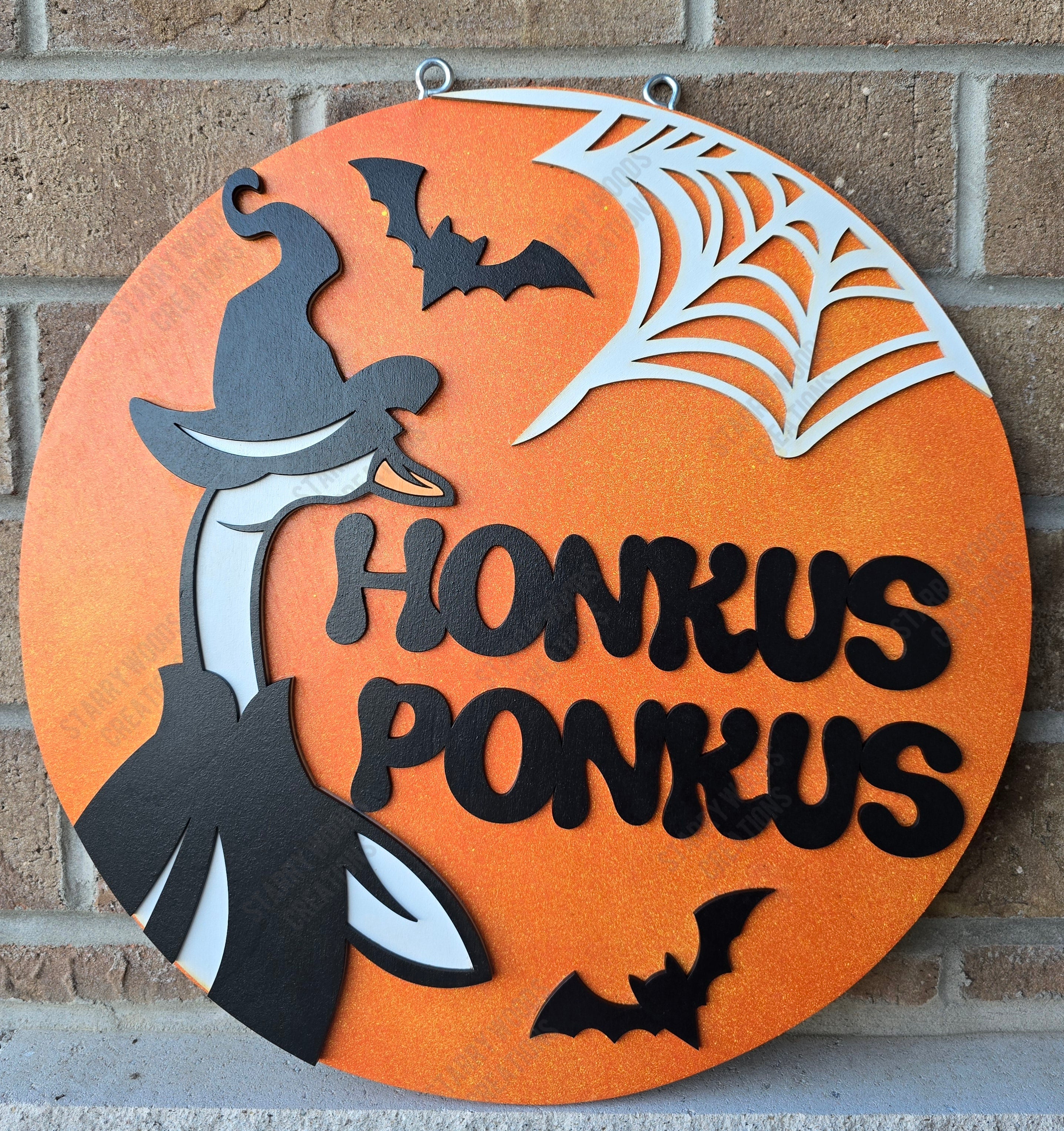 Halloween-themed decorative sign with 'Honkus Ponkus' text, goose in a halloween outfit, bats, and spider web on an orange background. Handmade in Ontario and customizable.