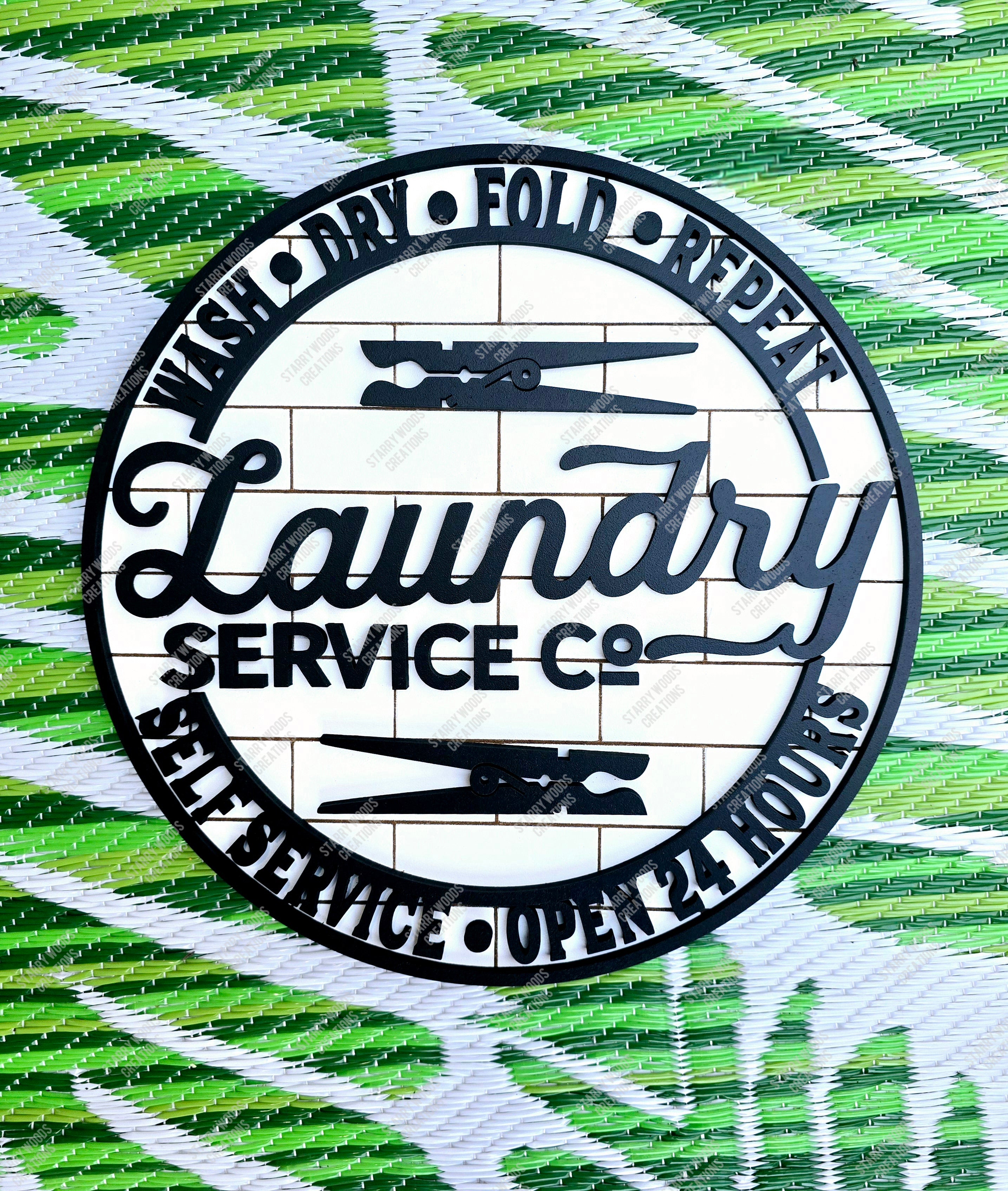 Circular logo sign for Laundry Service Co with 3D details on a brick patterned background