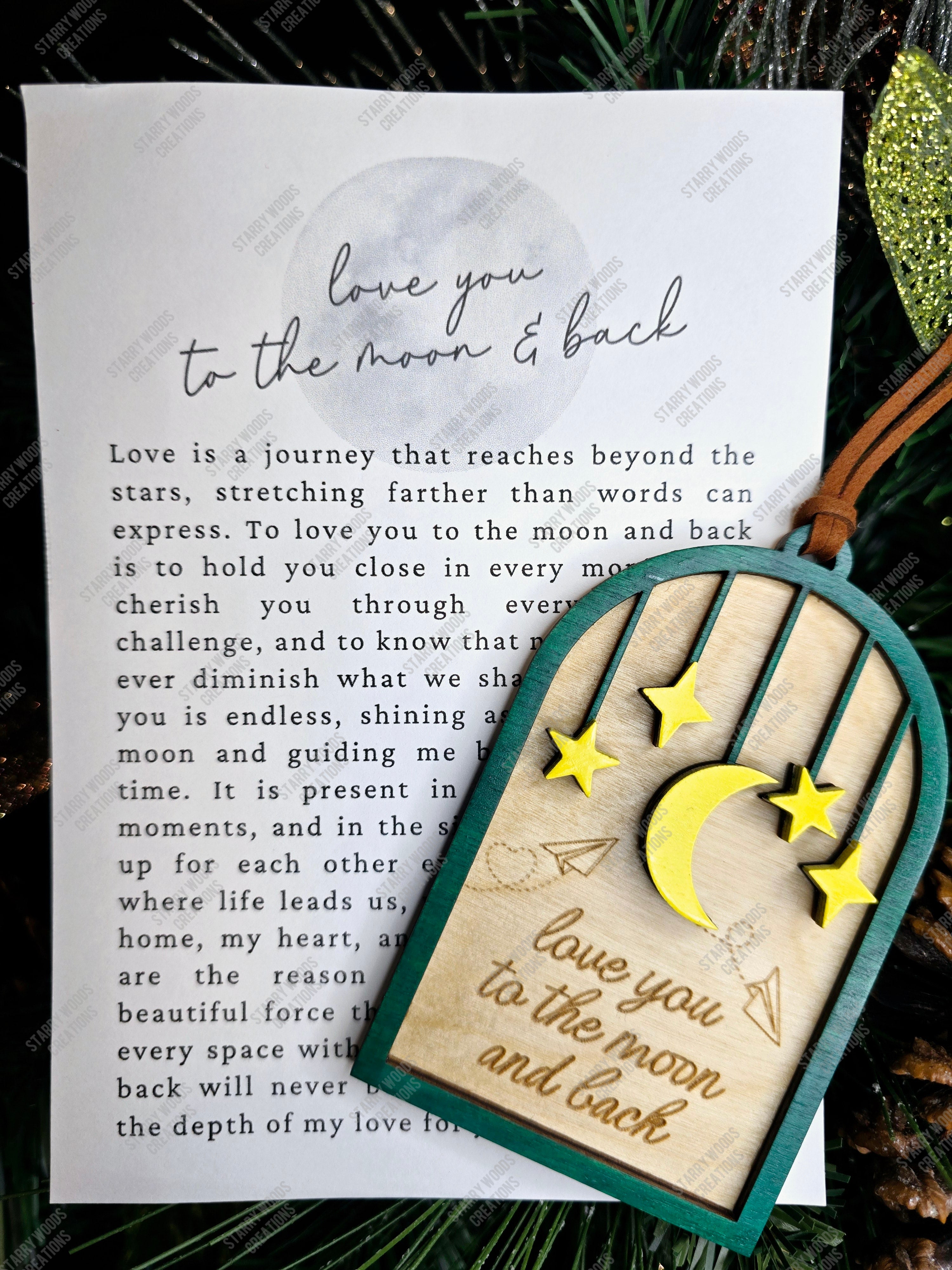 Card with 'love you to the moon and back' message and decorative elements on a textured background. Included with physical ornament, making it a sentimental and unique gift.