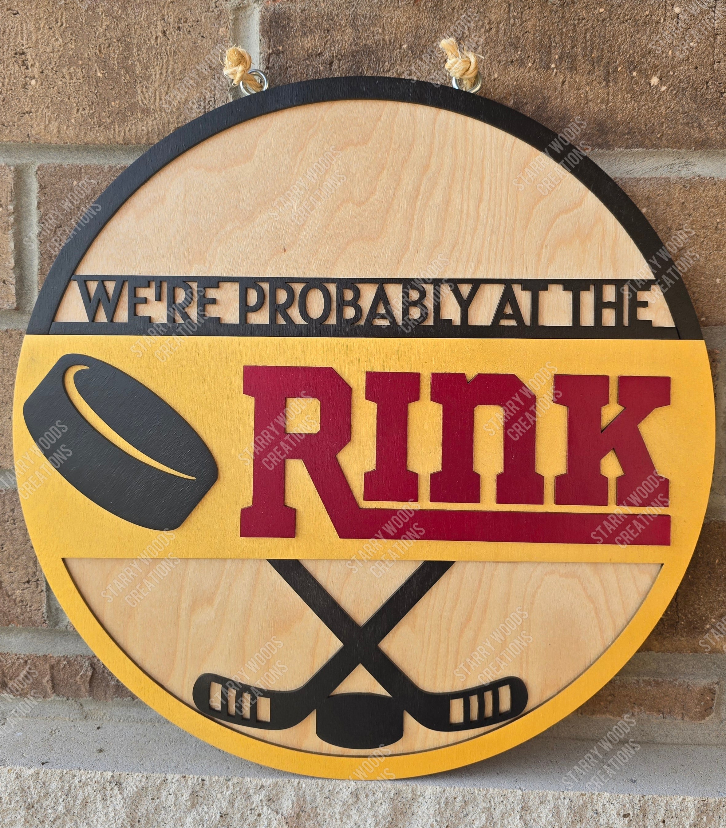 Round wooden sign with hockey-themed text and graphics on a brick wall background. Handmade in Quinte West and ready to hang.